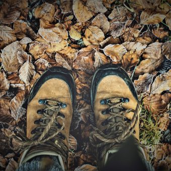 hiking boots on a bed of brown frosty leaves as an analogy to analogy for navigating life with hearing loss